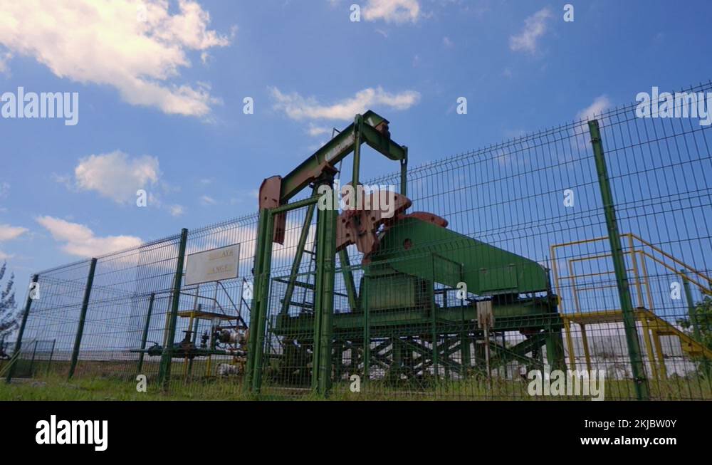Oil pumpjack (nodding donkey) in work. Oil industry in Seria, Brunei