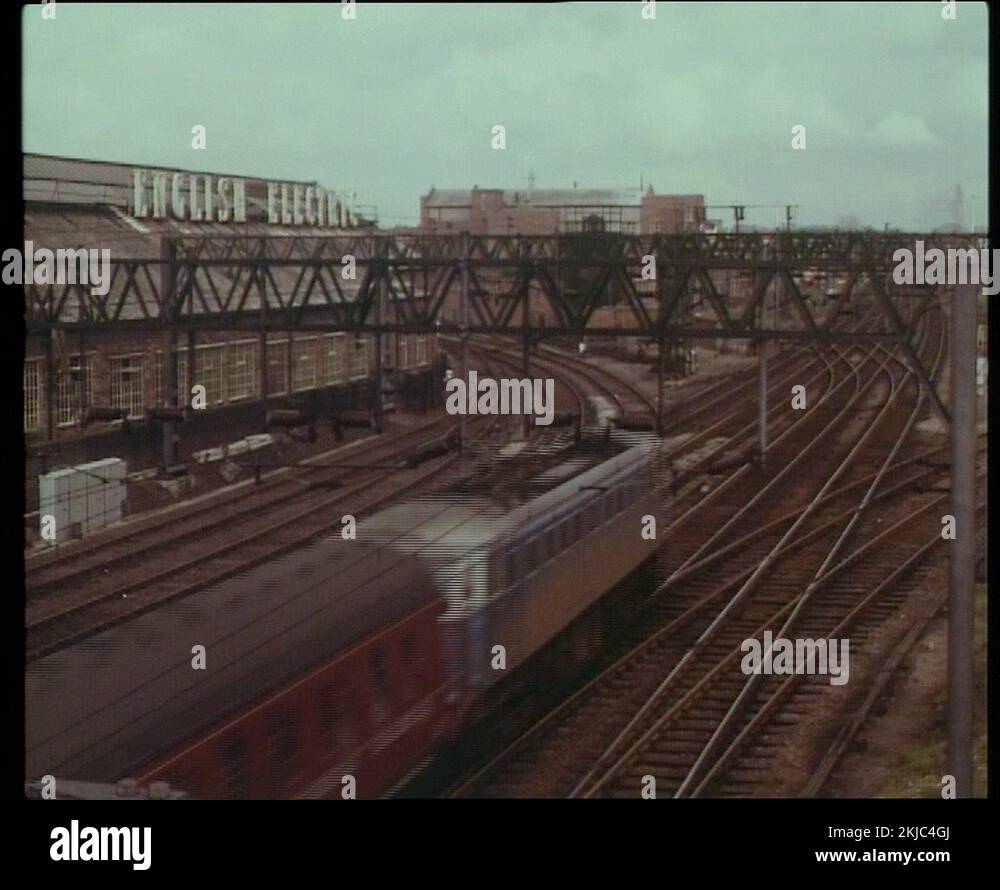 Shot of fast train driving through city and on bridge on rail track, UK