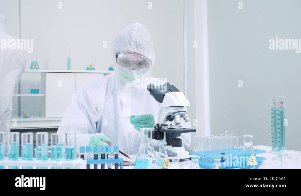 Scientist in Personal Protective Equipment (PPE) in laboratory Stock