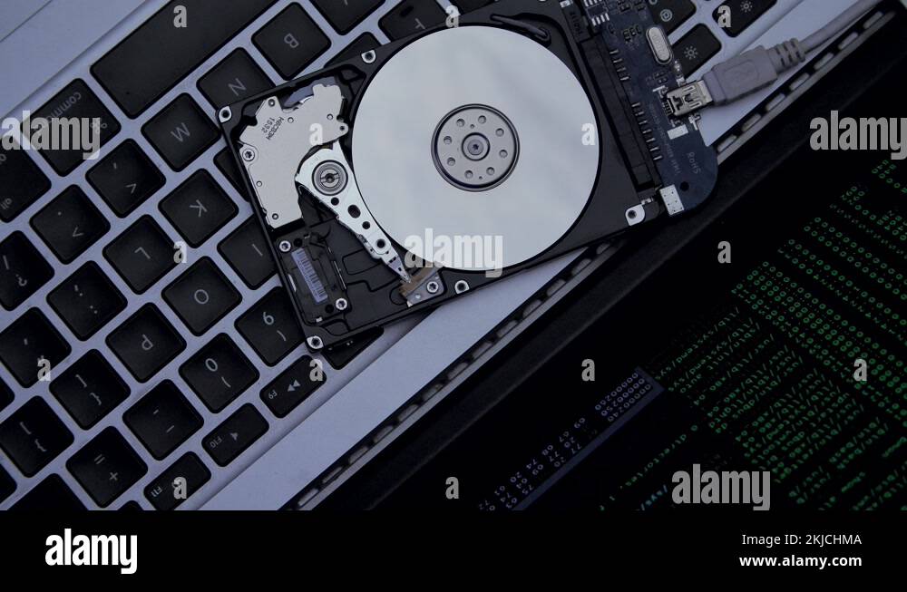Hard drive lies on the laptop keyboard, flashes and disk spins Stock
