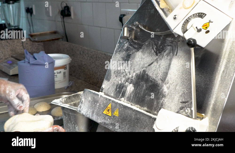 Chef in a professional restaurant kitchen making pizza from scratch