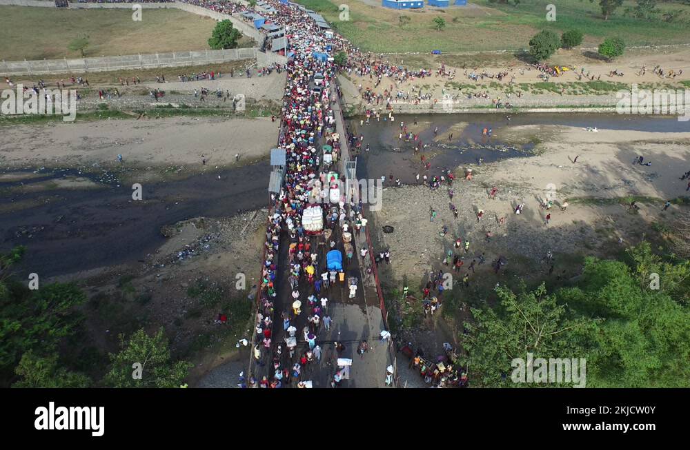 Dajabon bridge with crowd crossing border in Dominican Republic. Aerial
