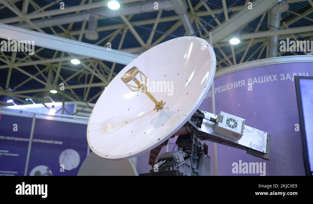 White rotating satellite dish antenna using to receive or transmit information Stock Video