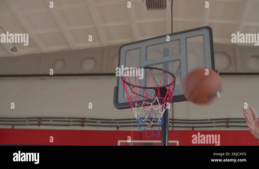 Black basketball player performing alley oop dunk Stock Video Footage