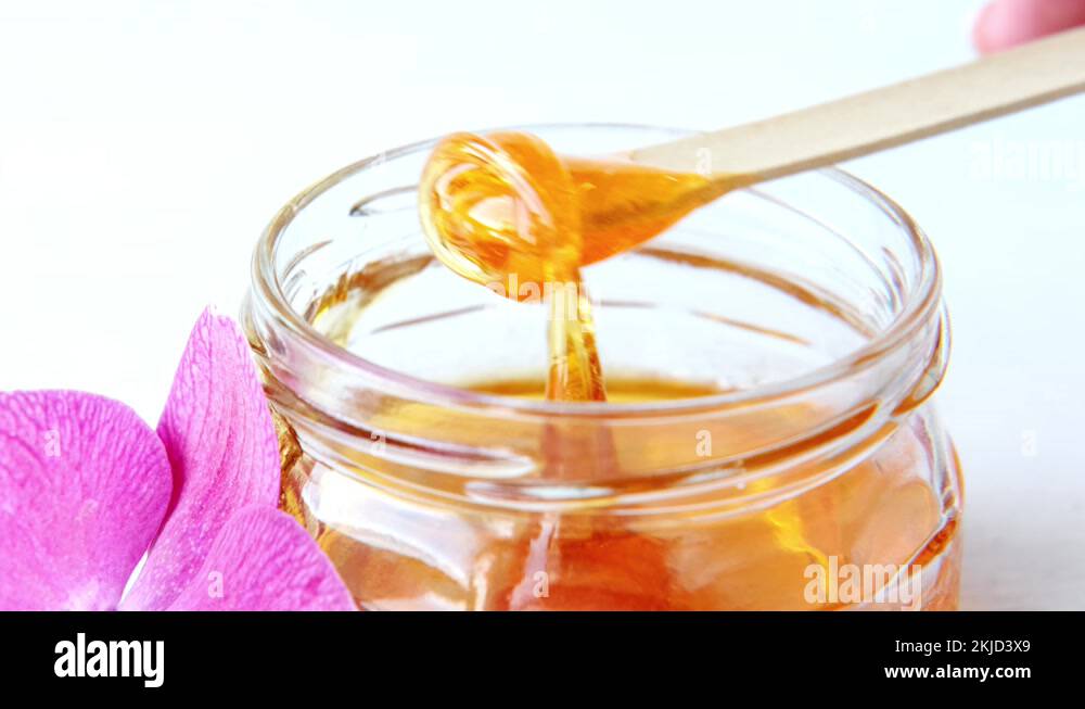 4k. sugar paste or wax honey for hair removing flows down from wooden