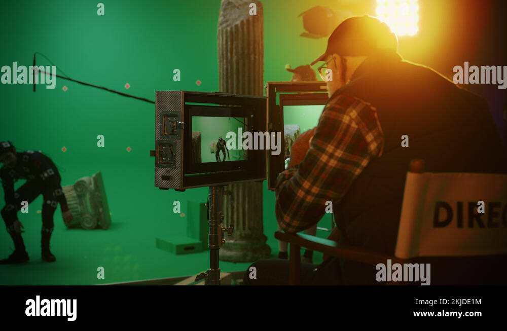 Director Looks at Displays Directs Green Screen CGI Scene with Actor in