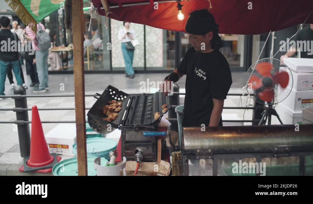 A Japanese Street Food Vendor Making Food During The Famous Gion