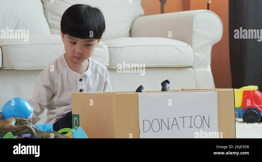 Little boy packing toys into donate box at home Stock Video Footage Alamy