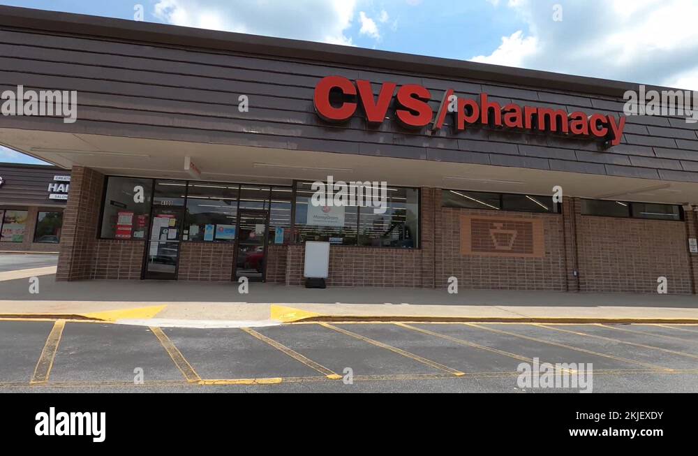 People wearing masks outdoors at a retail strip mall Dollar Tree CVS