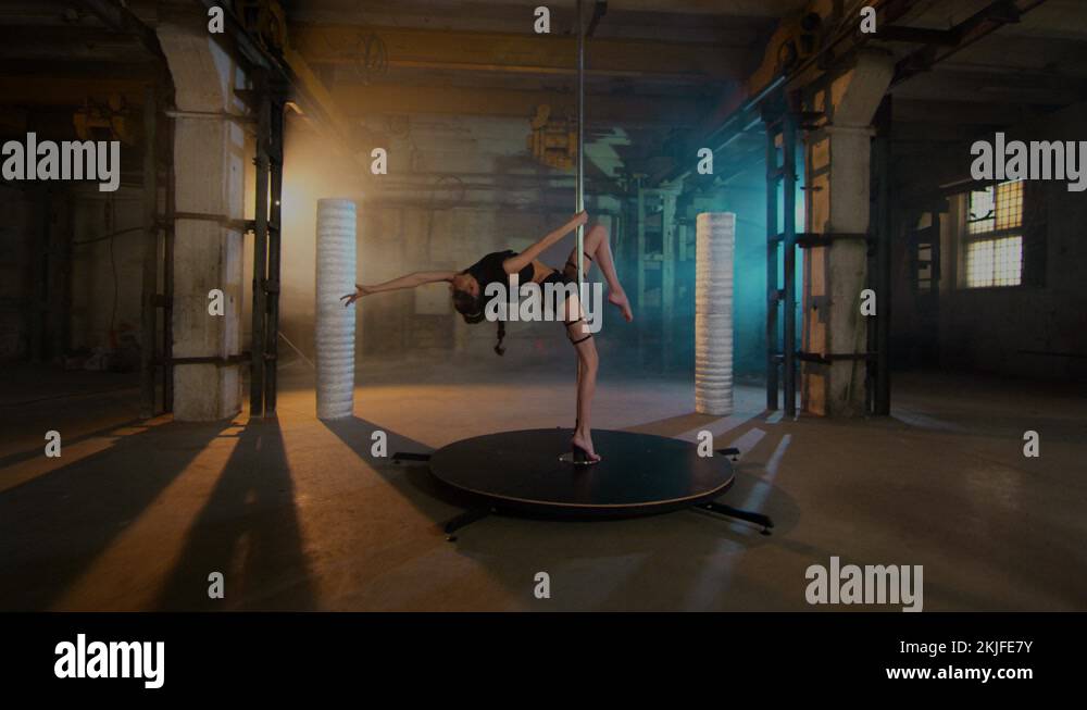 the gymnast stands in the back arch near the pylon and lifts her leg up