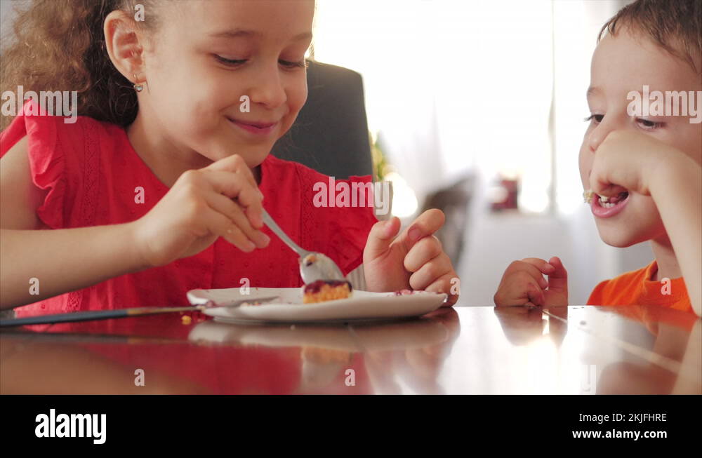 Pretty happy kids eating cheesecake. Sister and brother eat