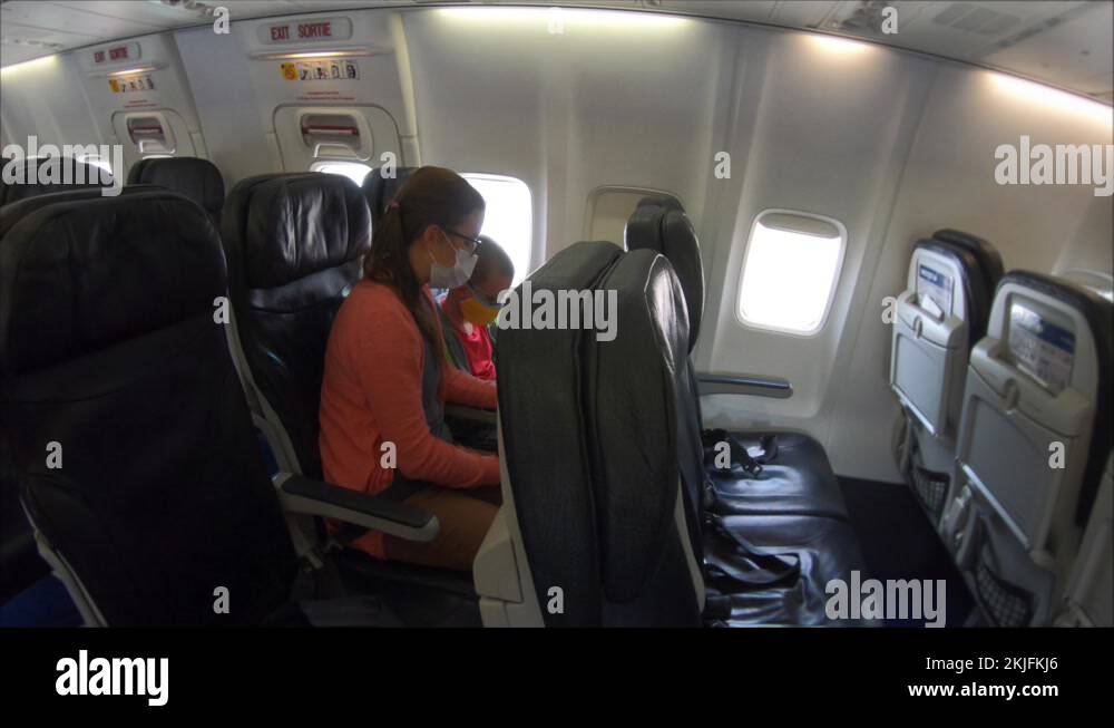 A mother and boy flying with masks on empty plane during covid 19 Stock Video Footage Alamy