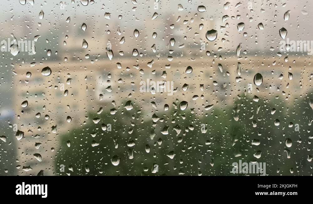 Heavy rain. Raindrops roll down the window pane during a windy thunderstorm Stock Video Footage