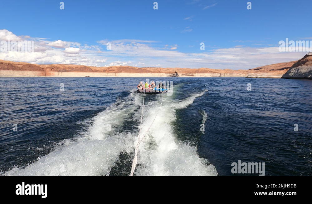 Family fun recreation tubing behind speed boat Lake Powell 4K Stock Video Footage Alamy