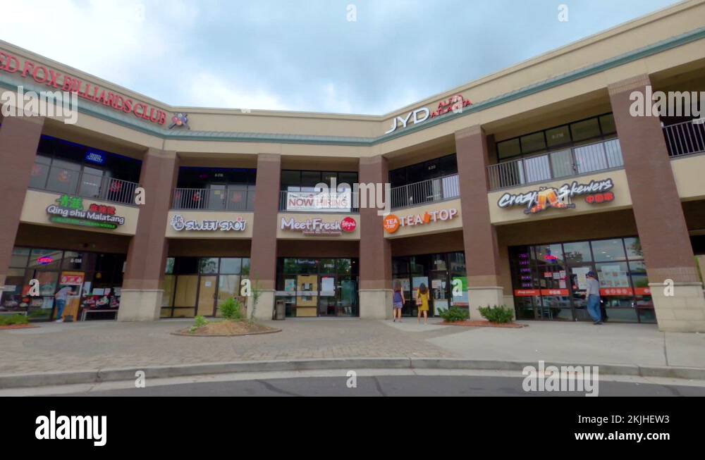 Two story retail strip mall shopping center people and storm clouds ...