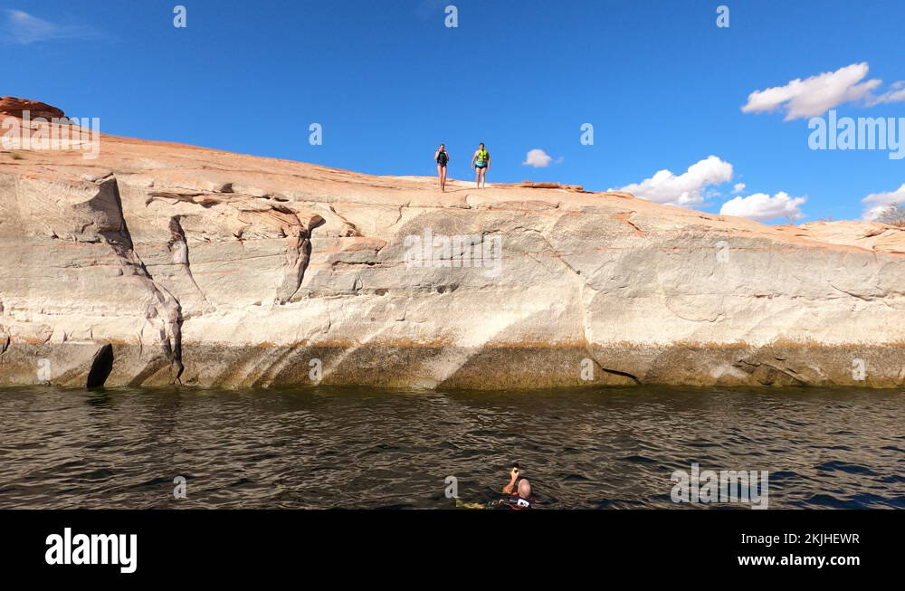Woman jumping off cliff into Lake Powell Utah 4K Stock Video Footage ...