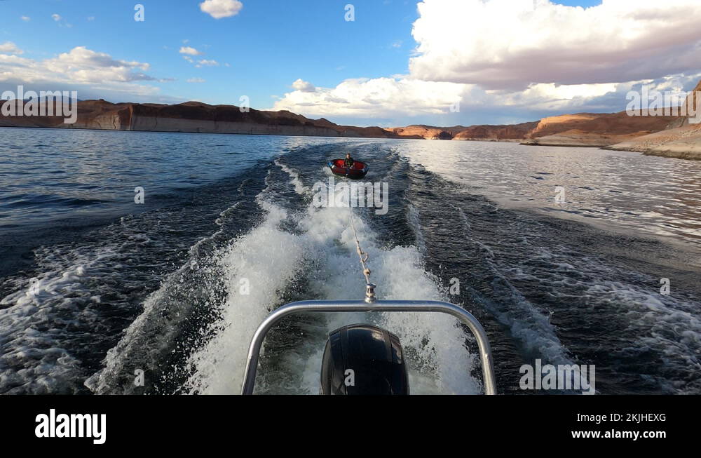 Boy on float tube behind a fast boat Lake Powell 4K Stock Video Footage