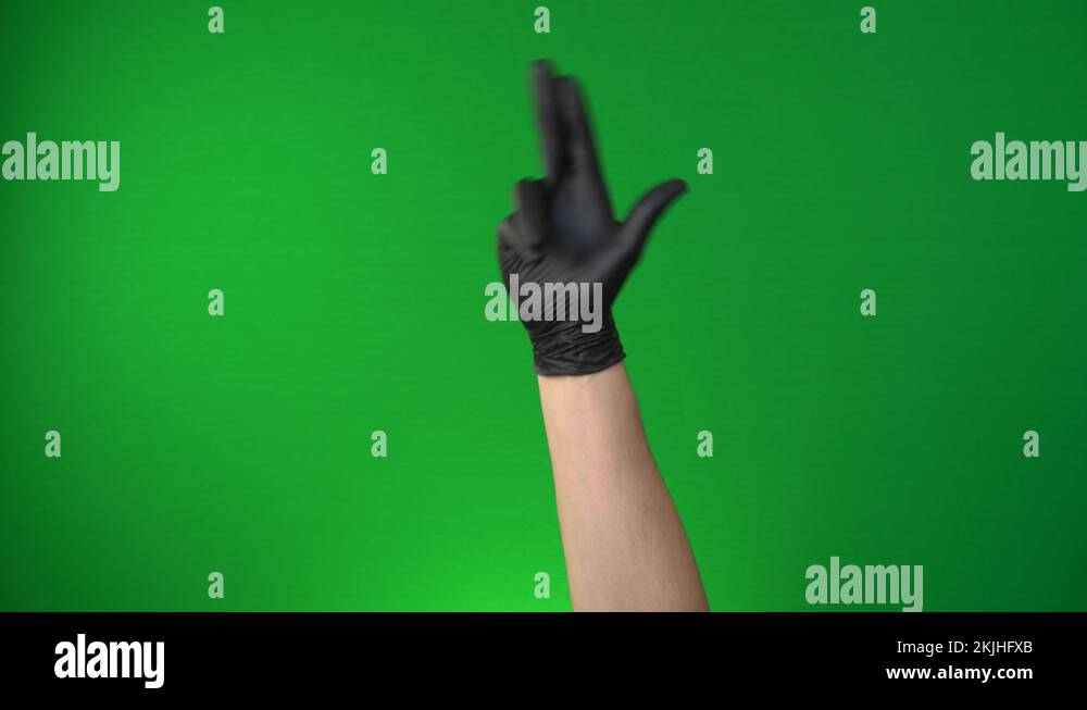Male hand showing the finger gun sign. Hand in a black medical glove