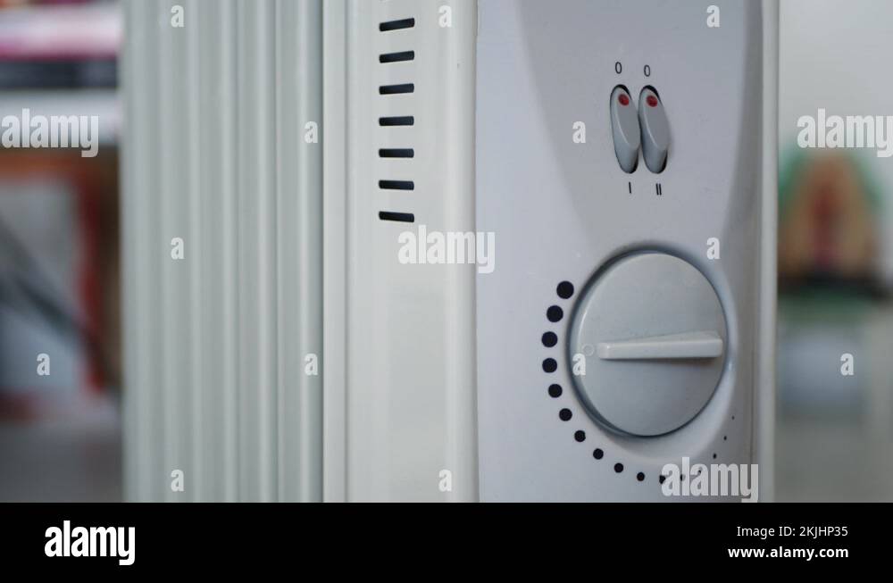 Man Start a Portable Electric Heater Warming a Cold Room from Home