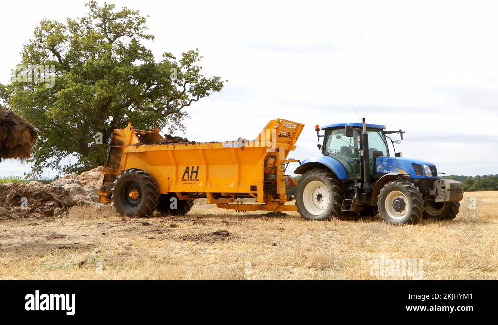 Farmer loading manure into a muck spreader. UK Stock Video Footage Alamy
