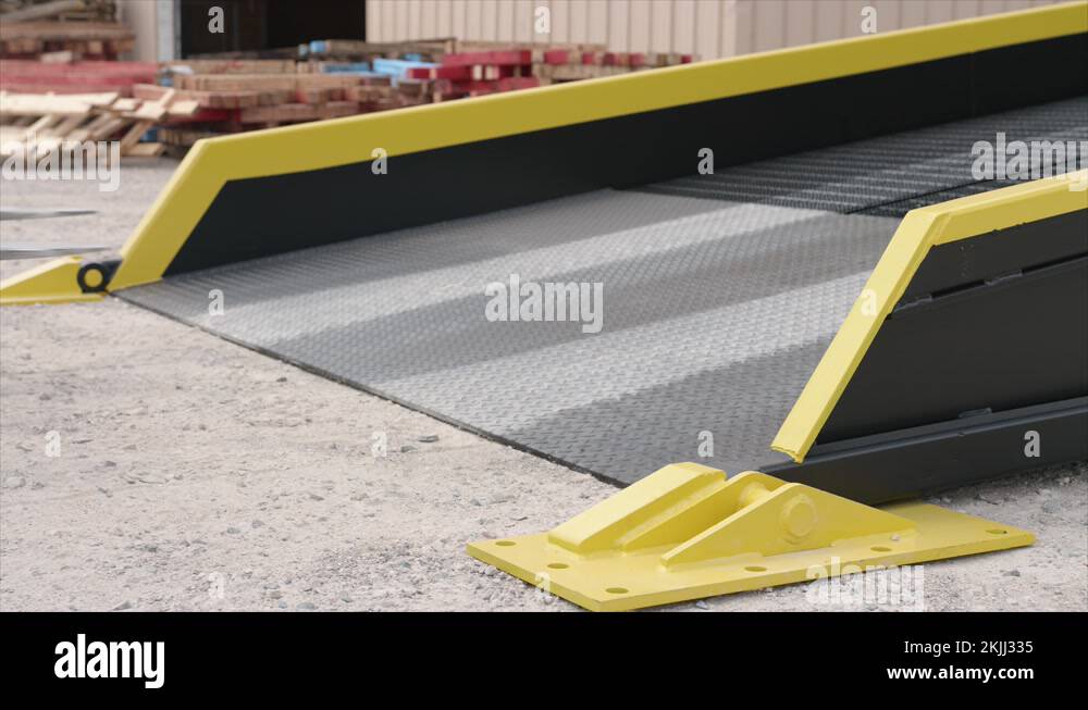 Forklift Loader Goes up Ramp To Load truck trailer equipment outdoors