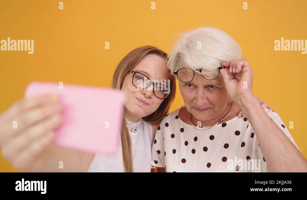 Senior And Young Woman Taking Selfies Granny Lifting Her Glasses Stock