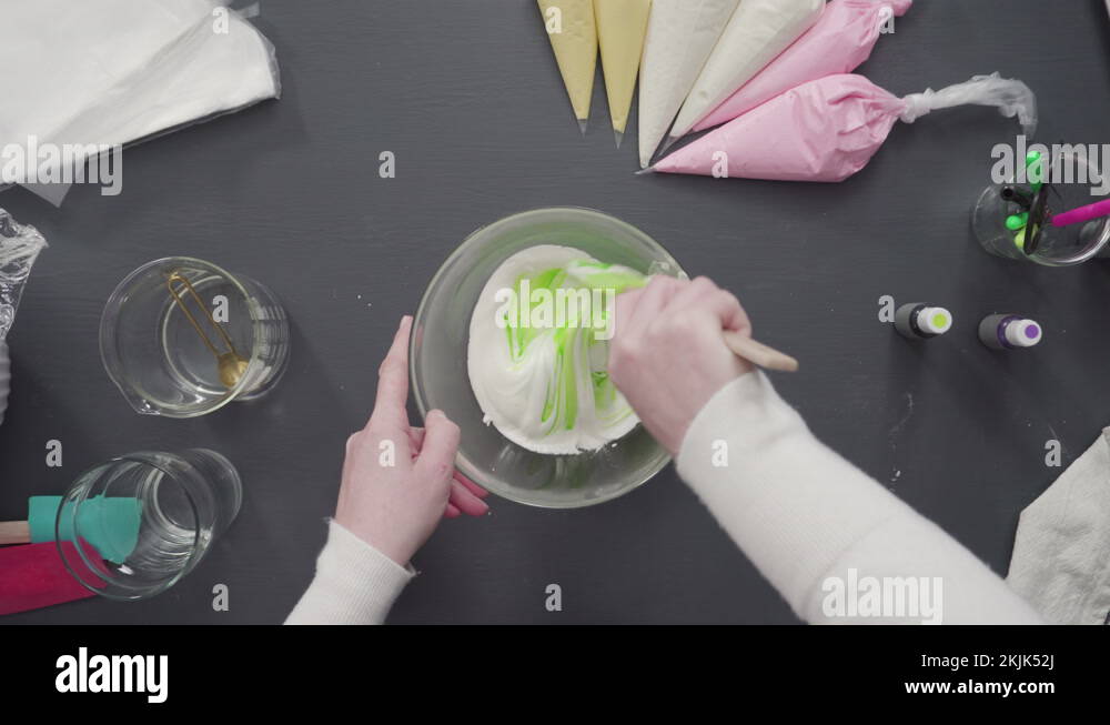 Mixing in food coloring into the royal icing to decorate sugar cookies