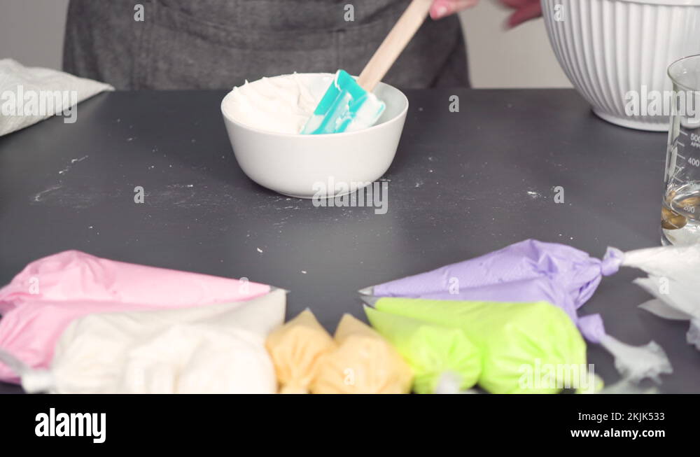 Mixing in food coloring into the royal icing to decorate sugar cookies
