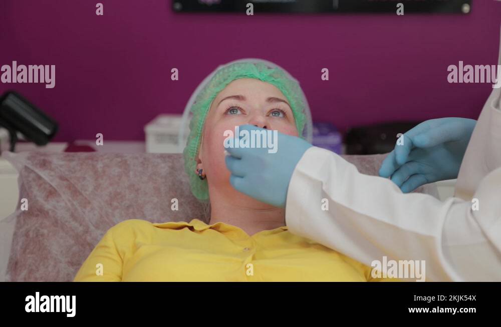 Beautiful woman rubbing lips before lip botox procedure Stock Video