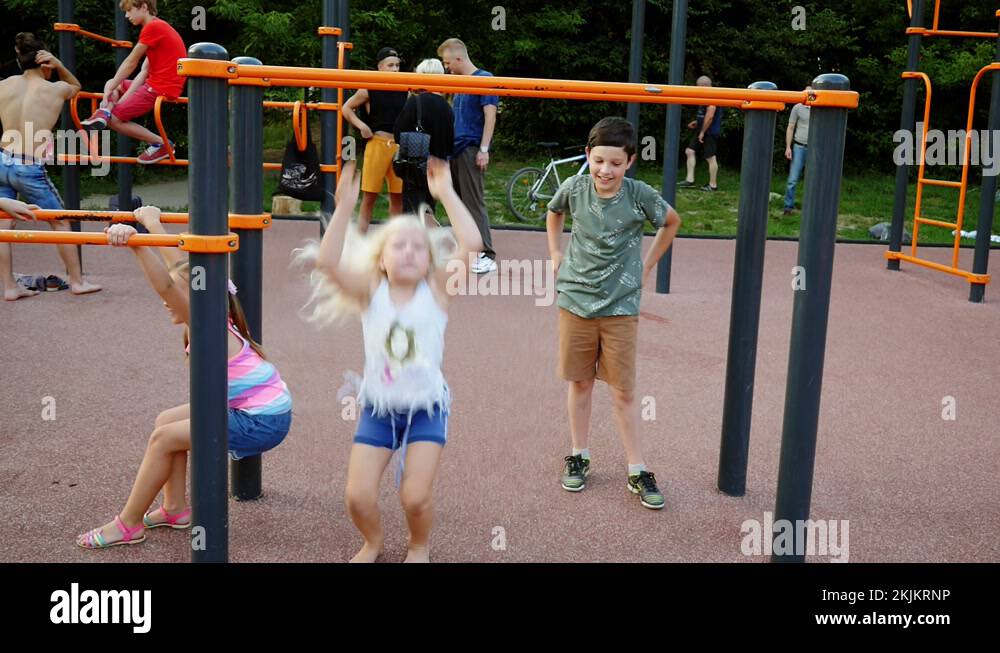 Children playing sports. Playground hanging on a horizontal bar Stock ...