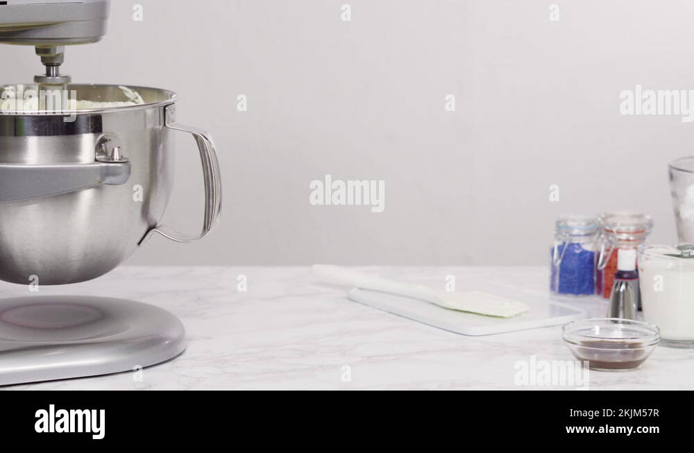 Mixing ingredients in standing kitchen mixer to make buttercream