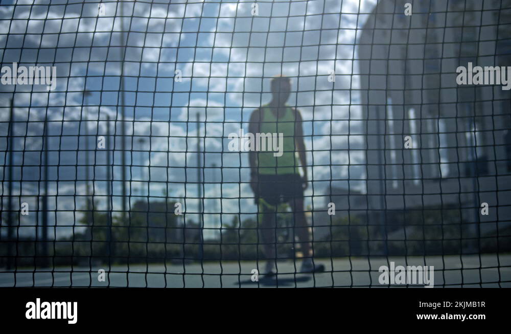 Stressed tennis player throwing and breaking a racket in anger and rage