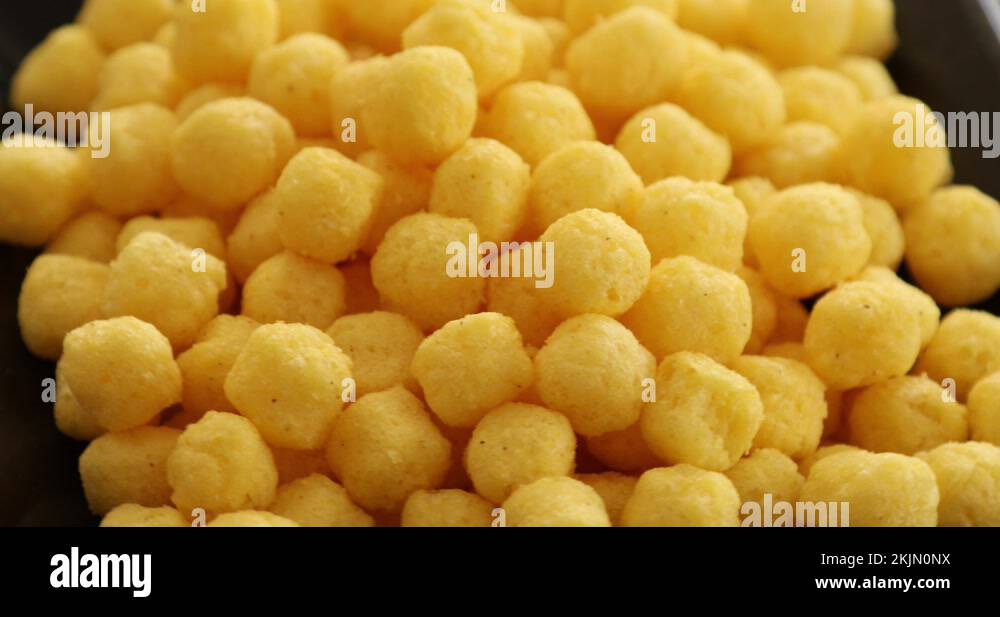 Puffed golden cheese balls rotating 2 Stock Video Footage Alamy