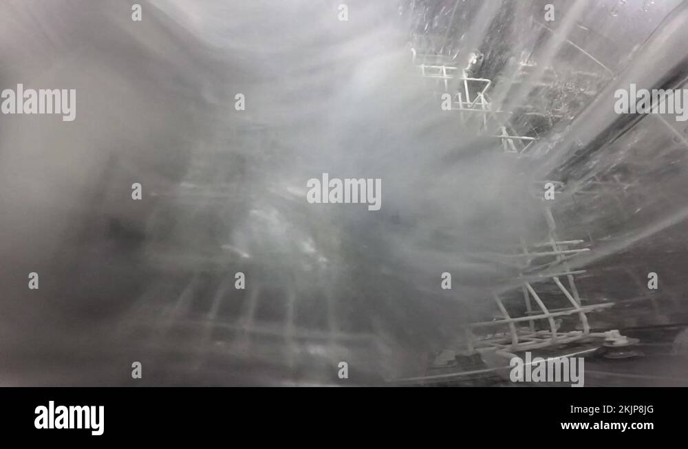 The process inside the dishwasher. Inside view of a dishwasher. Slow