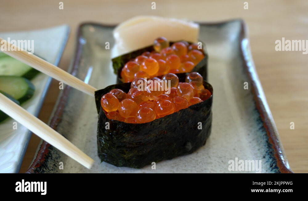 Chopsticks eating salmon roe sushi ikura maki Japanese food Stock Video