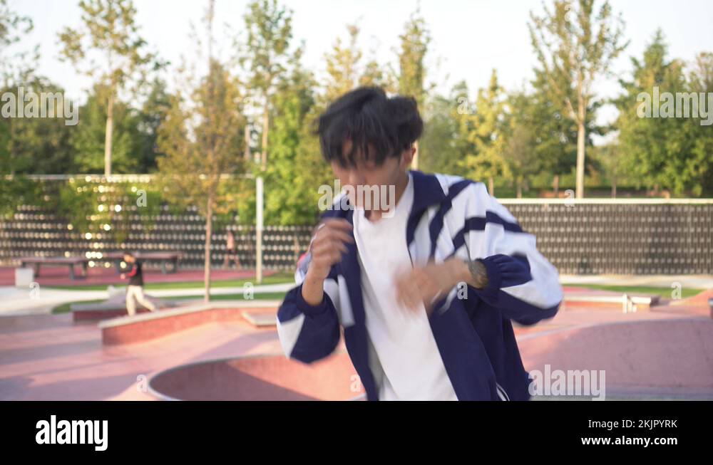Young Asian man dancing breakdance in the street. Modern man dancing