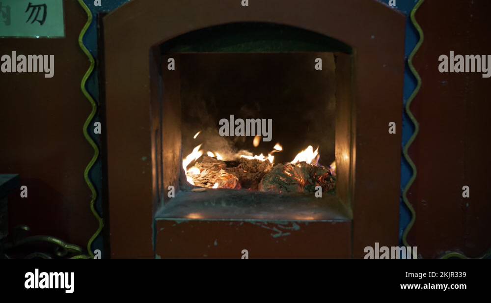 Joss paper / spirit money burning in a furnace in a traditional temple