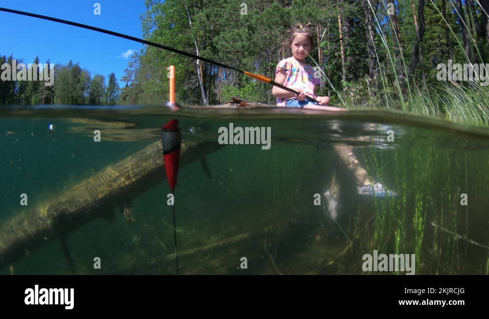 Little girl fishing with underwater view of fishing float and weed on a