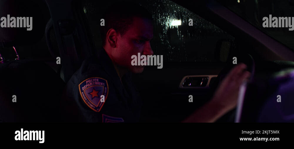 Police officer talking on CB radio while checking info on a laptop