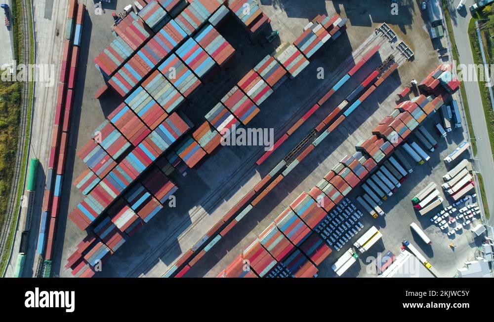Overhead drone footage of shipping containers with transport network ...