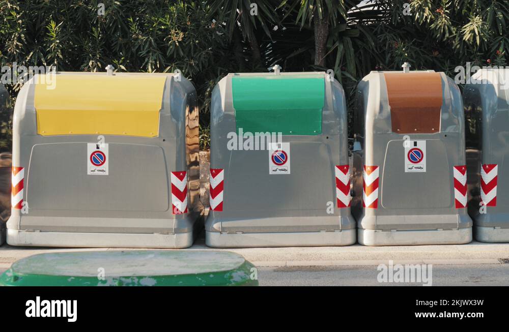 Public trash and recycling bins line the a city street in Barcelona