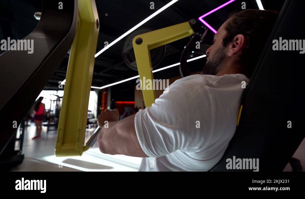 sportsman is lifting weights in sport equipment, training arms muscles in gym Stock Video