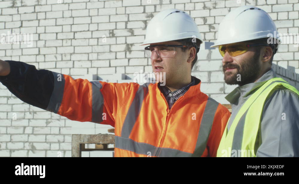 View of Contactor showing construction site to colleague Stock Video Footage ...