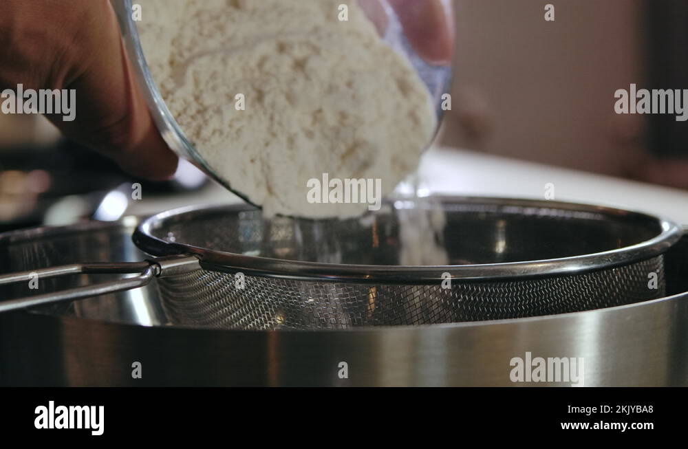 Closeup Flour Sifting with Sieve for Bread and Pastry Making Cooking