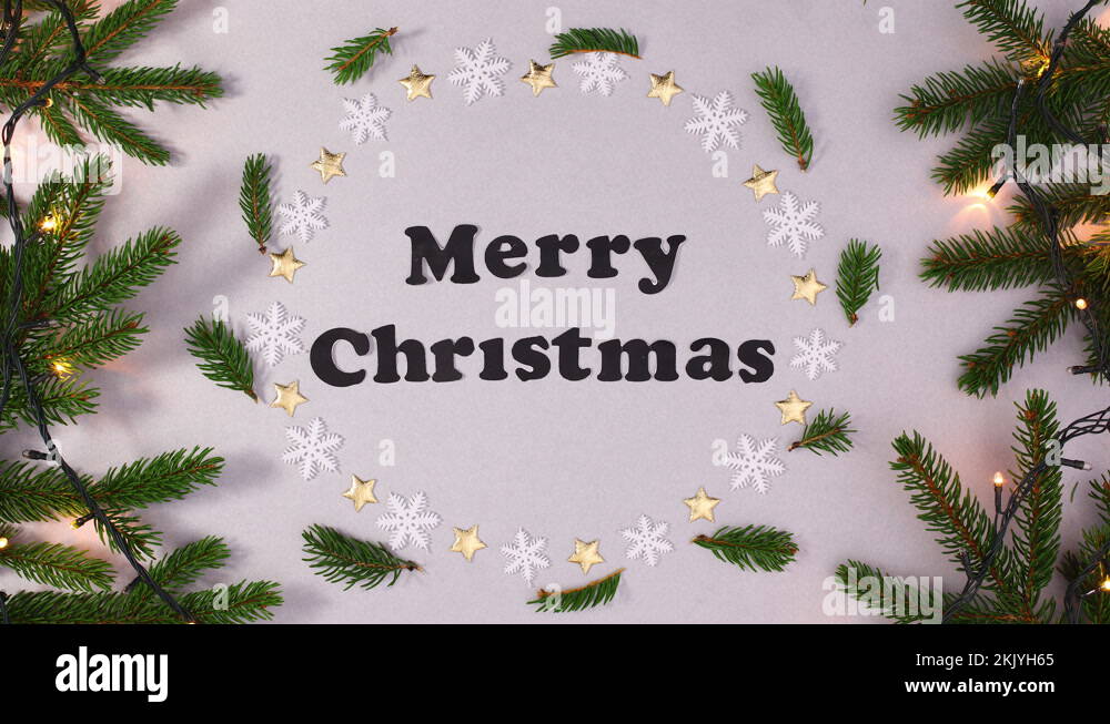 Blinking lights on Merry Christmas frame with pine branches.Stop motion
