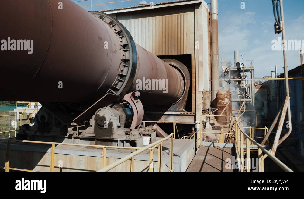 Huge industrial tube rotating, big rusty pipe on factory spinning