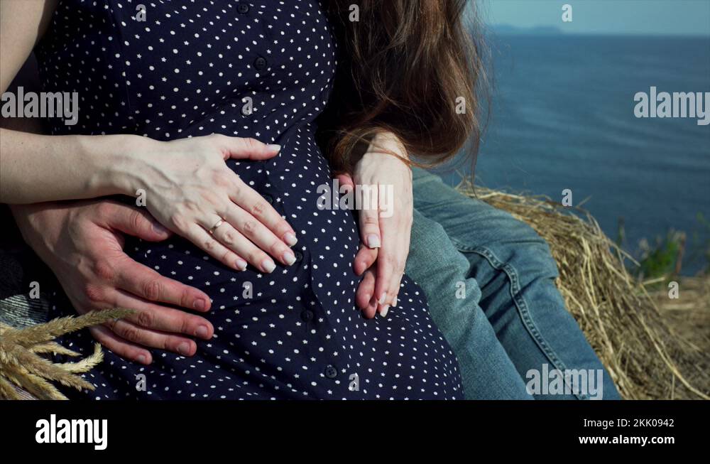 Big belly of pregnant woman. Man and woman are caressing pregnant belly