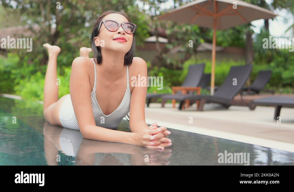 Lying on her stomach and kicking her feet slowly in the air, an