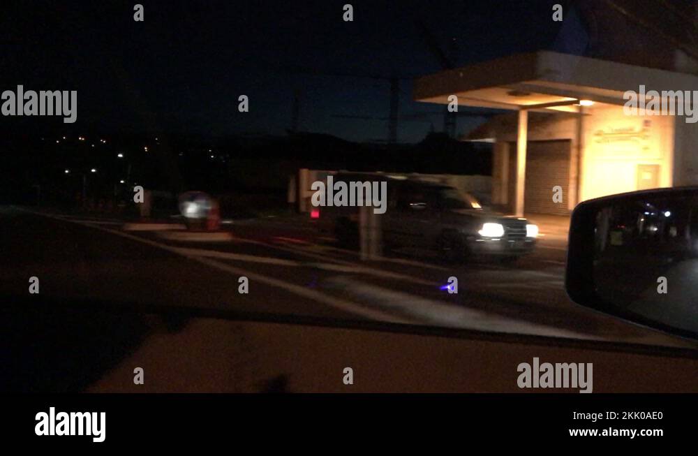 Driving by a 24 hour gas station at night in Auckland New Zealand Stock