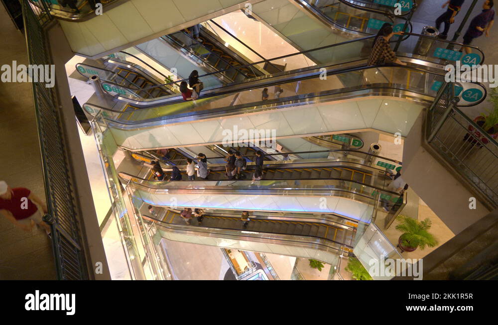 jakarta city center famous mall crowded escalator hall top view 4k